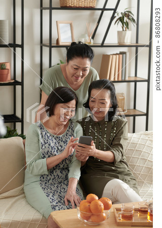 Senior Friends Watching Funny Videos Senior Friends Watching Funny Videos 86808293