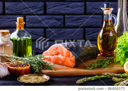piece of raw salmon fish with spices and herbs 86808375