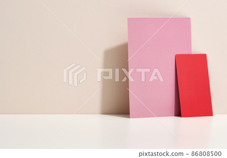 blank pink and red cardboard sheet of paper with shadow on white table. Template for flyer, announcement blank pink and red cardboard sheet of paper with shadow on white table. Template for flyer, announcement 86808500