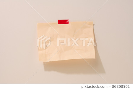 blank rectangular crumpled beige sheet of paper glued on a light beige background. Place for an inscription, announcement 86808501
