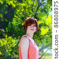 Portrait of a red-haired happy girl in park 86808975