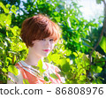 Portrait of a red-haired happy woman in park 86808976