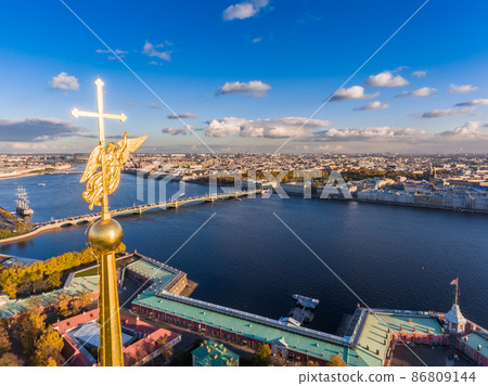 Russia, St. Petersburg, Aerial landscape of Peter and Paul cathedral at sunset, walls of fortress, Golden autumn, panorama landscape, golden spire with cross and angel, drawbridges, river Neva 86809144