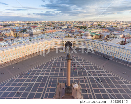 Aerial view of Palace Square and Alexander Column at sunset, a dome of Kazanskiy Cathedral on background, the Winter Palace, walking a little people Aerial view of Palace Square and Alexander Column at sunset, a dome of Kazanskiy Cathedral on background, the Winter Palace, walking a little people 86809145