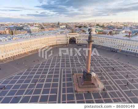 Aerial view of Palace Square and Alexander Column at sunset, a dome of Kazanskiy Cathedral on background, the Winter Palace, walking a little people Aerial view of Palace Square and Alexander Column at sunset, a dome of Kazanskiy Cathedral on background, the Winter Palace, walking a little people 86809149