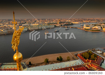 The golden angel on the cross of the Peter and Paul Fortress at sunrise, landmarks of St. Petersburg on background, Isaac cathedral, Admiralty, Rostral columns, Winter Palace The golden angel on the cross of the Peter and Paul Fortress at sunrise, landmarks of St. Petersburg on background, Isaac cathedral, Admiralty, Rostral columns, Winter Palace 86809160