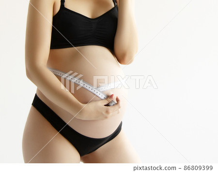 Beautiful pregnant young woman in clothes for Beautiful pregnant young woman in clothes for 86809399
