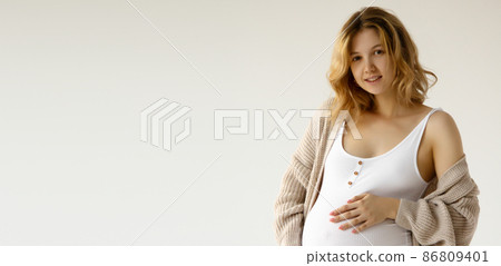 Woman standing and touching with hands her big 86809401