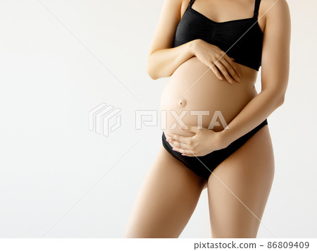 Woman standing and touching with hands her naked 86809409