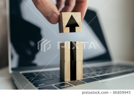 Arrow up on cubes and notebooks. Business success concept. Arrow up on cubes and notebooks. Business success concept. 86809945