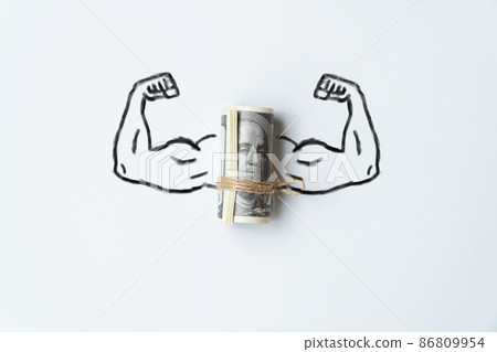 The concept of a strong world currency. Muscle hands with a bunch of us dollars money. The concept of a strong world currency. Muscle hands with a bunch of us dollars money. 86809954