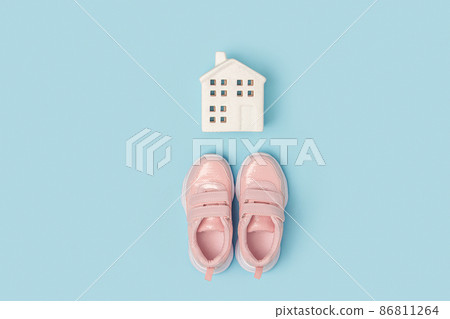 Pink sneakers and white ceramic house on a blue background. Creative sport concept. Top view Flat lay Pink sneakers and white ceramic house on a blue background. Creative sport concept. Top view Flat lay 86811264