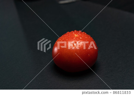 Fresh tomatoes on black background 86811833