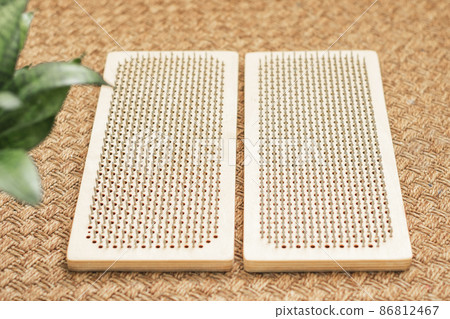 Sadhu board with nails lies on the floor, preparing for exercises. Practice standing on nails at home 86812467