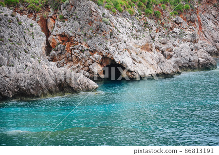 Colorful cliffs by the water edge. Natural reserve Zingaro. Colorful cliffs by the water edge. Natural reserve Zingaro. 86813191