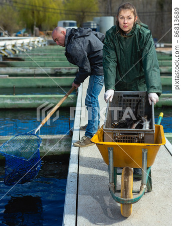 Male and female fish farm workers Male and female fish farm workers 86813689