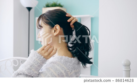 A woman holding her hair 86814628