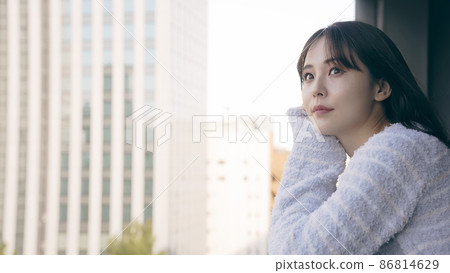 A woman looking out on the veranda A woman looking out on the veranda 86814629