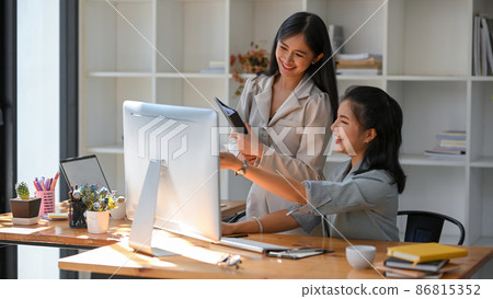 Business colleague are enjoying working together in the office. 86815352