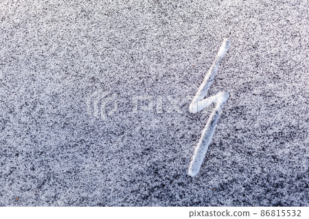 Black soot from the boiler room on white snow. Natural background. Snow mixed with coal soot, poor ecology. Environmental pollution  86815532