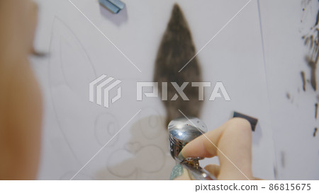 Woman artist learns to paint with airbrush with acrylic dye, paper and easel. Concept modern art, airbrushing, aerography, graffiti, aerosol spray 86815675