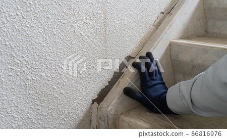 Workers inspecting stairs and walls | Deterioration of joints 86816976