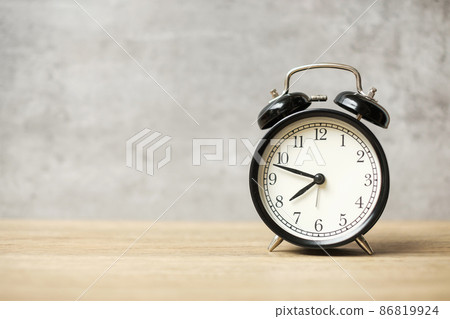 Vintage alarm clock on wooden table background and copy space for text. Activity, daily routine, morning, workout and Work life balance concept 86819924