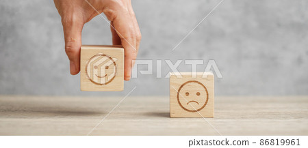 hand holding smile face block. Customer choose Emoticon for user reviews. Service rating, ranking, customer review, satisfaction, mood, mental health and feedback concept hand holding smile face block. Customer choose Emoticon for user reviews. Service rating, ranking, customer review, satisfaction, mood, mental health and feedback concept 86819961
