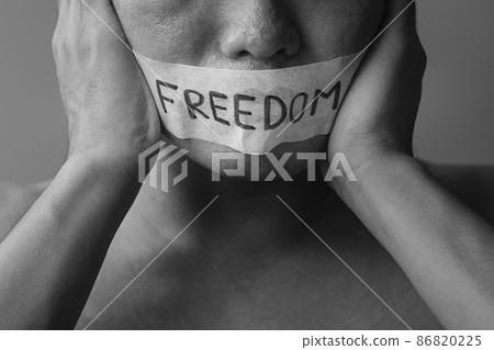 Man with mouth sealed in adhesive tape with Freedom message. Free of speech, freedom of press, Human rights, Protest dictatorship, democracy, liberty, equality and fraternity concepts 86820225