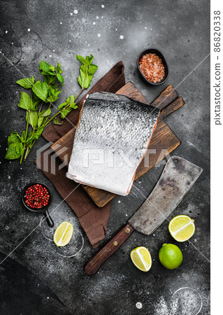 Raw whole salmon cut, on black dark stone table background, top view flat lay 86820338