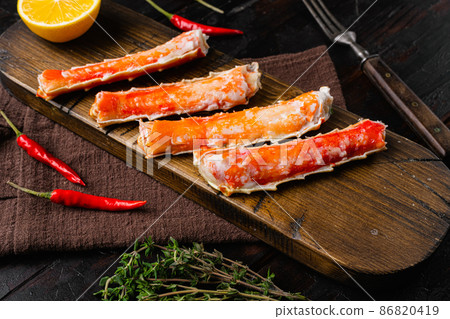Cooked crab legs, on old dark wooden table background 86820419