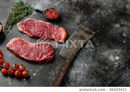 Raw Marbled sirloin Beef Steaks, on black dark stone table background, with copy space for text Raw Marbled sirloin Beef Steaks, on black dark stone table background, with copy space for text 86820431