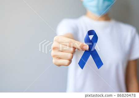 March Colorectal Cancer Awareness month, Woman holding dark Blue Ribbon for supporting people living and illness. Healthcare, hope and World cancer day concept March Colorectal Cancer Awareness month, Woman holding dark Blue Ribbon for supporting people living and illness. Healthcare, hope and World cancer day concept 86820478