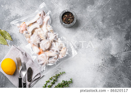 Frozen seafood pack, on gray stone table background, top view flat lay, with copy space for text 86820517