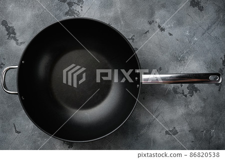 Empty Wok skillet with copy space for text or food with copy space for text or food, top view flat lay , on gray stone table background 86820538