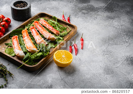 Cooked Organic Alaskan King Crab Legs with Butter, on gray stone table background, with copy space for text 86820557