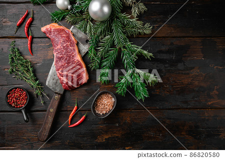 New-York steak with a Christmas tree, on old dark wooden table background, top view flat lay, with copy space for text New-York steak with a Christmas tree, on old dark wooden table background, top view flat lay, with copy space for text 86820580
