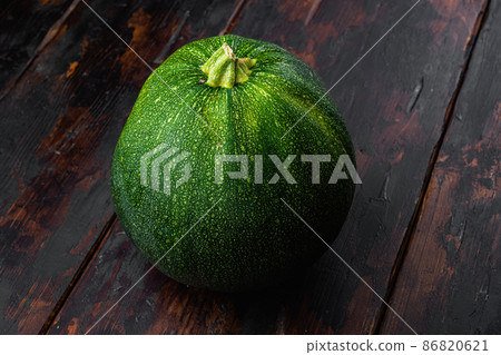Fresh vegetable Zucchini, on old dark wooden table background Fresh vegetable Zucchini, on old dark wooden table background 86820621