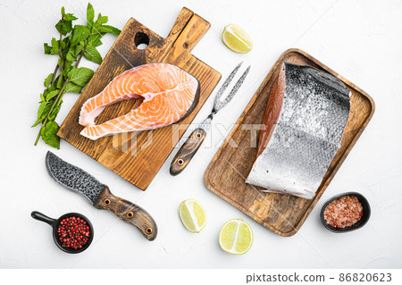 Raw cut salmon fish, on white stone table background, top view flat lay Raw cut salmon fish, on white stone table background, top view flat lay 86820623