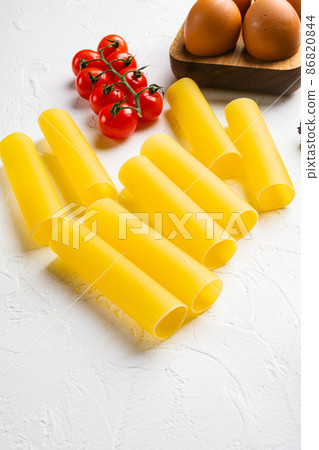 Cannelloni stuffed raw ingredients, on white stone table background, with copy space for text Cannelloni stuffed raw ingredients, on white stone table background, with copy space for text 86820844