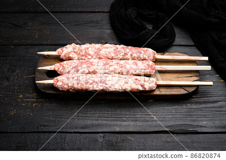 Raw shish kebab skewers, on black wooden table background, with copy space for text Raw shish kebab skewers, on black wooden table background, with copy space for text 86820874