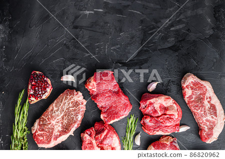 Set of various alternative raw meat steaks over black background top view. With space for text. Set of various alternative raw meat steaks over black background top view. With space for text. 86820962