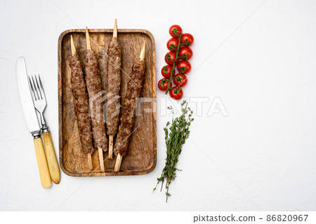 Grilled kebab, on white stone table background, top view flat lay, with copy space for text Grilled kebab, on white stone table background, top view flat lay, with copy space for text 86820967