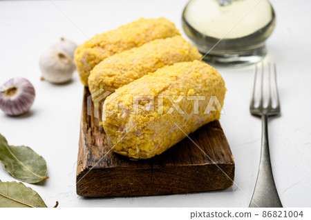 Breaded chicken cutlet, on white stone table background Breaded chicken cutlet, on white stone table background 86821004