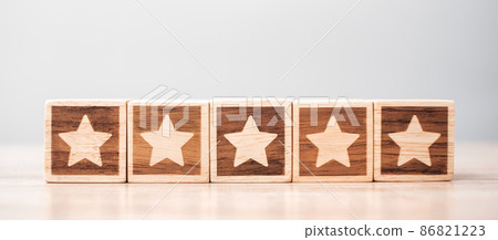 star symbol block on table background. Service rating, ranking, customer review, satisfaction, evaluation and feedback concept star symbol block on table background. Service rating, ranking, customer review, satisfaction, evaluation and feedback concept 86821223