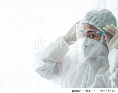 woman doctor in PPE (Personal Protective Equipment) for working in Covid19 ward 86821248