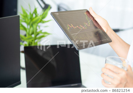business man holding smart device with stock graph 86821254