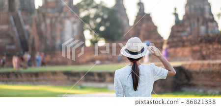 Tourist Woman in white dress visiting to ancient stupa in Wat Chaiwatthanaram temple in Ayutthaya Historical Park, summer, Asia and Thailand travel concept Tourist Woman in white dress visiting to ancient stupa in Wat Chaiwatthanaram temple in Ayutthaya Historical Park, summer, Asia and Thailand travel concept 86821338