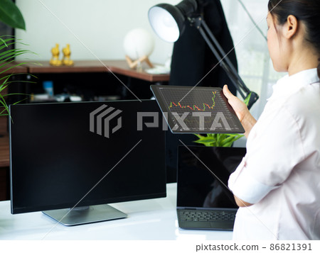 business man holding smart device with stock graph business man holding smart device with stock graph 86821391