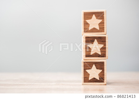 star symbol block on table background. Service rating, ranking, customer review, satisfaction, evaluation and feedback concept star symbol block on table background. Service rating, ranking, customer review, satisfaction, evaluation and feedback concept 86821413